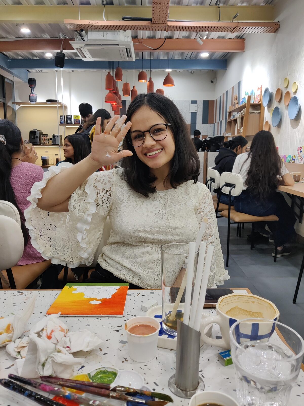 Vinanti smiling at Wabi Sabi with paint on her hand