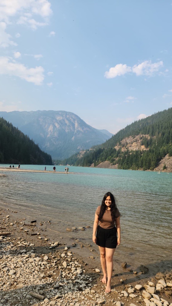 Vinanti standing beside a mountain lake